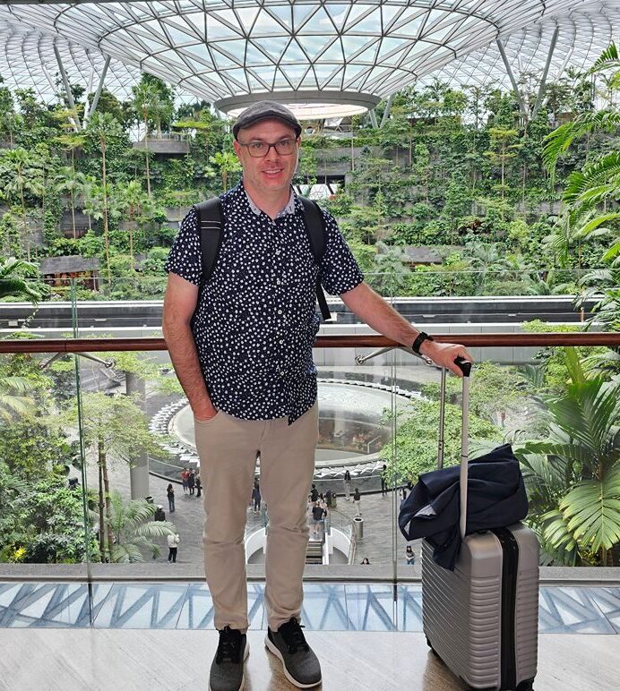 Ron at Singapore airport ready with carry-on luggage.